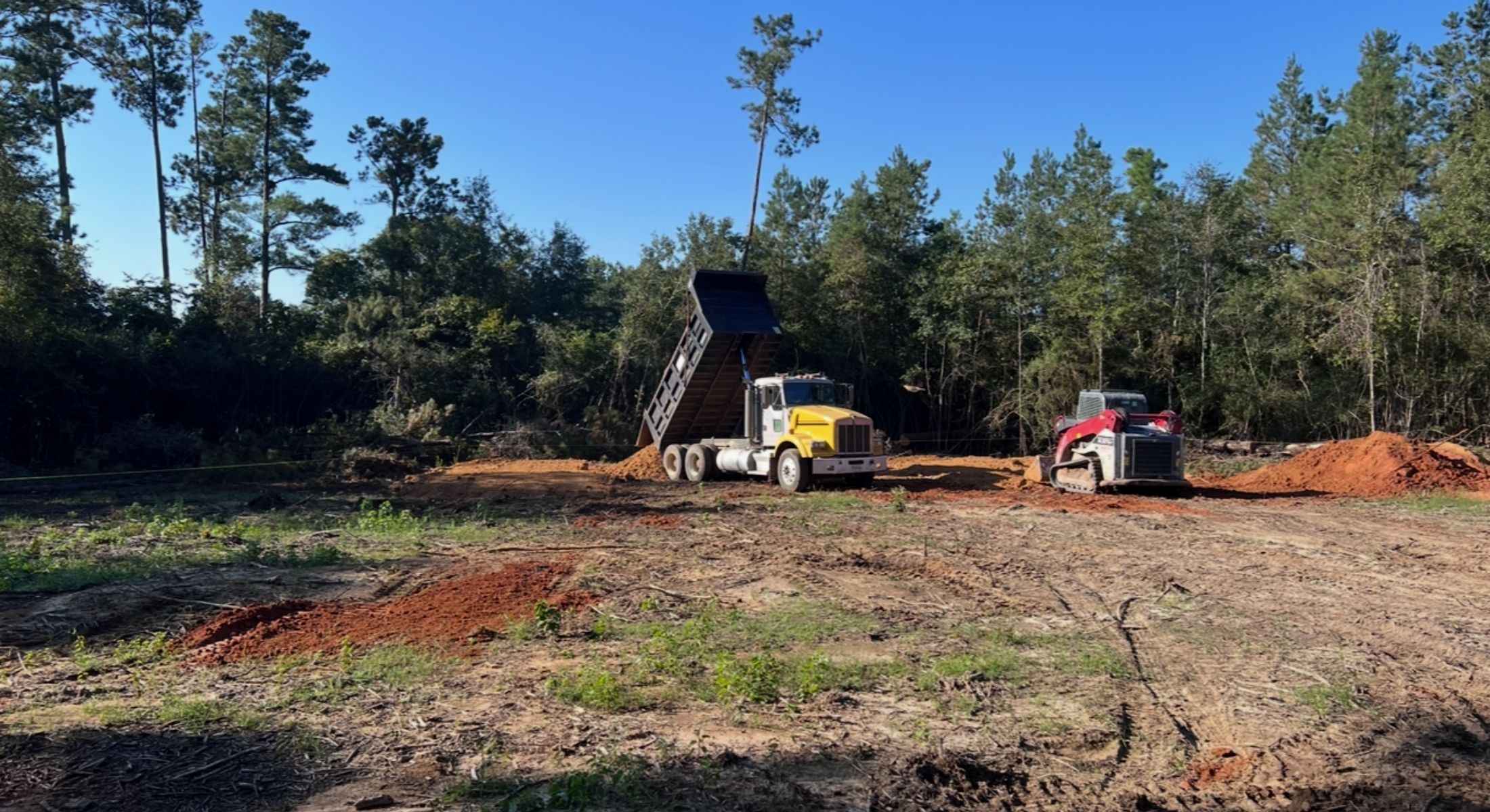 freshly cleared land with a dump truck
